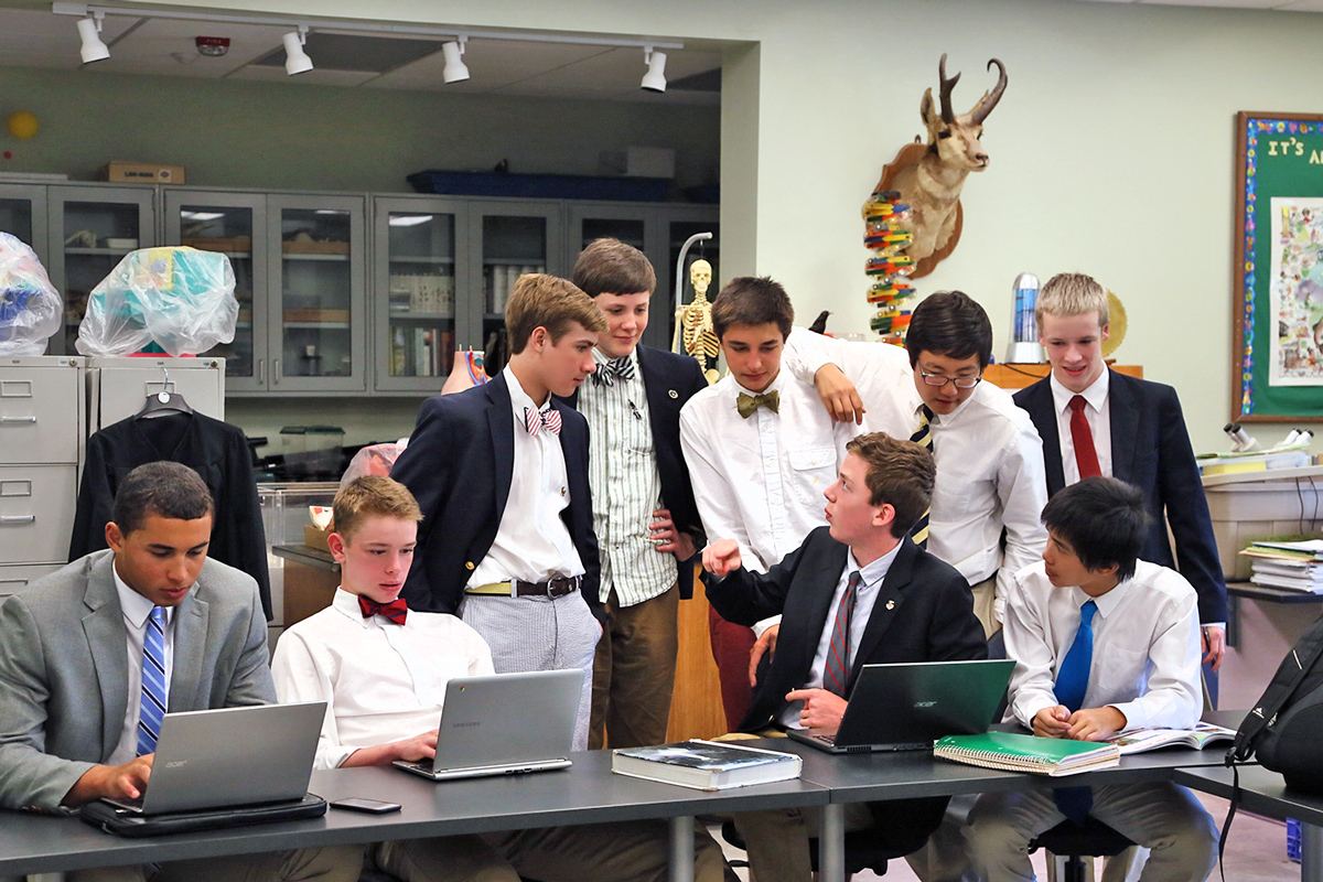 Students work on laptops in a biology class.